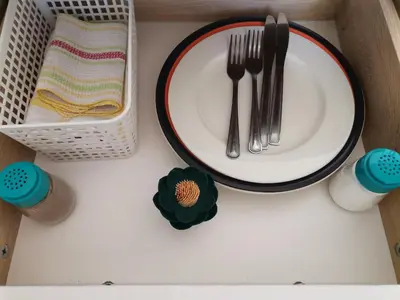 a white plate with fork and knife on a table at Onyx on Sycamore in Cape Town