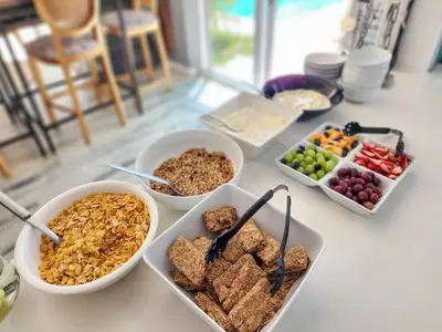 a table topped with bowls of different types of food at Salt Boutique Guest House in Bloubergstrand