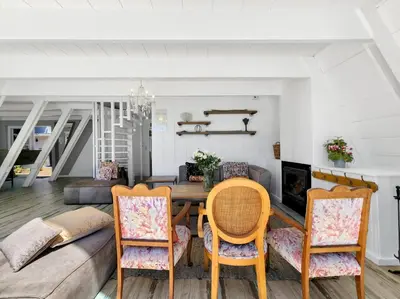a living room with a table and chairs at Salt Boutique Guest House in Bloubergstrand