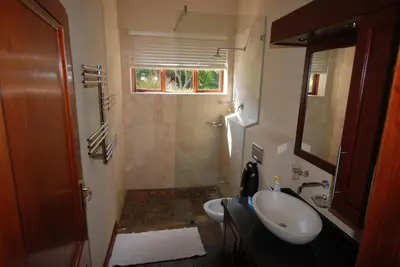 a small bathroom with a sink and a shower at Kingsbury Cottage in Breerivier