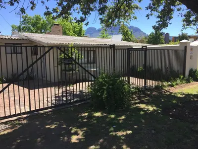 a fence in front of a house at Just a Bed parking on street in Stellenbosch