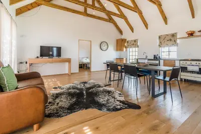a living room with a couch and a table at Druk My Niet Wine Estate in Paarl