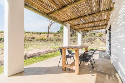 a table and chairs on a patio with a view at Druk My Niet Wine Estate in Paarl