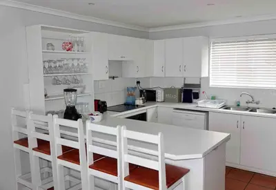 a kitchen with white cabinets and a white counter top at Whales & Waves in Hermanus