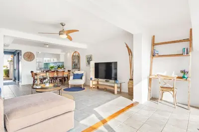 a living room with a couch and a tv at Marechale Way in Cape Town