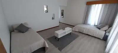 a living room with a bed and a couch at Koraalboom Guesthouse in Wolseley