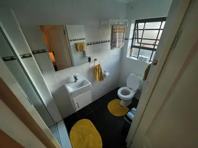 a small bathroom with a sink and a toilet at Ridgeworth, Tygervalley in Cape Town