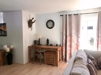 a living room with a desk and a couch at African Holiday home in Table View in Cape Town