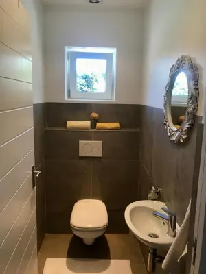 a bathroom with a toilet and a sink at African Holiday home in Table View in Cape Town