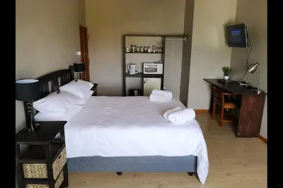 a hotel room with two beds and a television at Eagle's Crest in Worcester