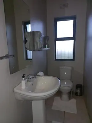 a white bathroom with a sink and a toilet at Eagle's Crest in Worcester