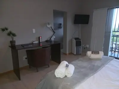 a bedroom with a desk and a bed with towels on it at Eagle's Crest in Worcester
