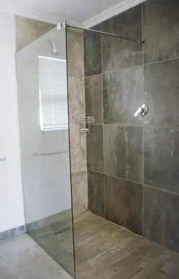 a shower with a glass door in a bathroom at Pringle Nest in Cape Town