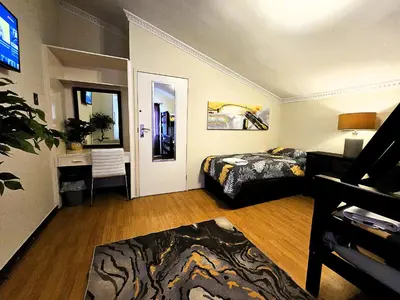 a room with two beds and a desk in it at Walters Lane Luxury Accommodation main house - No loadshedding in Cape Town