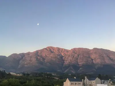 a view of a mountain range with houses and trees at The Lemon Tree in Franschhoek in Franschhoek