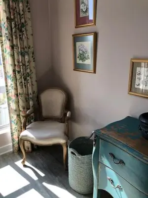 a room with a chair and a dresser and a window at The Lemon Tree in Franschhoek in Franschhoek