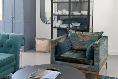 a living room with a chair and a table at No. 6 The Yard in Franschhoek