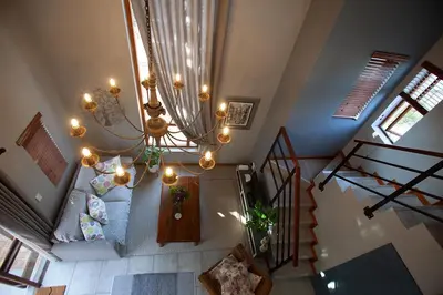 an overhead view of a living room with a chandelier at Culemborg Cottage in Cape Town