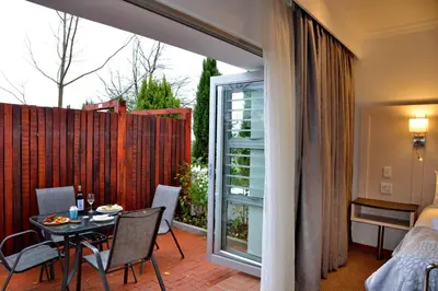 a patio with a table and chairs and a balcony at Val Du Charron Wine & Leisure Estate in Wellington