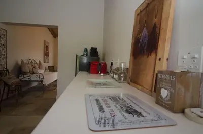 a kitchen counter with a cutting board on top of it at Rouxwil Country House in Caledon