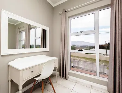 a white desk in a room with a window at Villa Eike in Grabouw