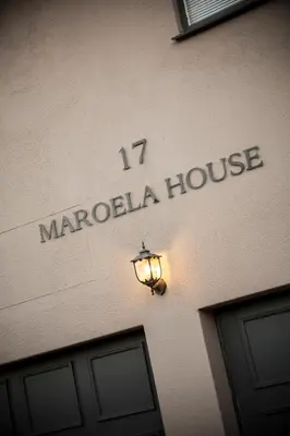 a sign for a marocola house on the side of a building at Maroela House Guest Accommodation in Bellville