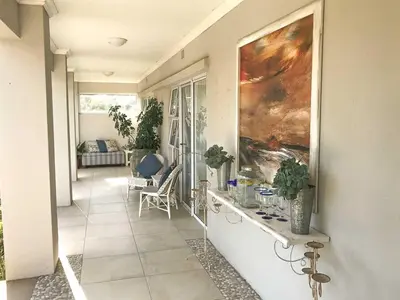 a hallway of a house with a painting on the wall at Lavender Suite in Cape Town
