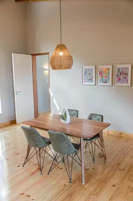 a dining room table with chairs and a light fixture at Opstal Stay in Rawsonville