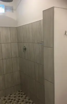 a shower with a glass door in a bathroom at Ammabed Accommodation in Caledon