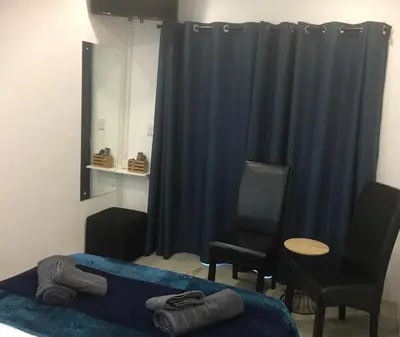 a bedroom with a bed and a table and chairs at Ammabed Accommodation in Caledon