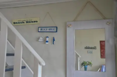 a room with a staircase and a mirror and a door at Beach Cottage 1 in Hermanus