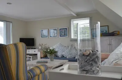 a living room with a couch and a table at Beach Cottage 1 in Hermanus