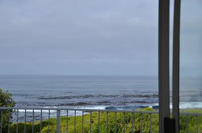 a view of the ocean from a balcony at Beach Cottage 1 in Hermanus