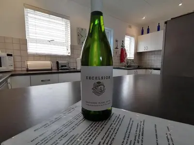 a bottle of wine sitting on top of a kitchen counter at Beach Cottage 2 in Hermanus
