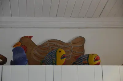 a group of birds sitting on top of a shelf at Beach Cottage 2 in Hermanus