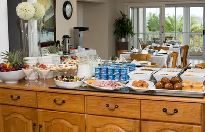 a buffet filled with food on a table at Bell Rosen Guest House in Bellville