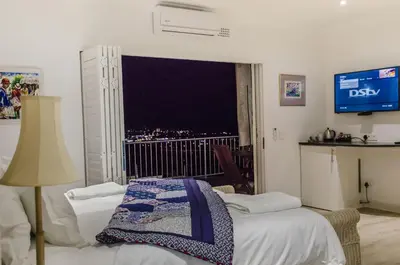 a room with two beds and a window with a view at Somerset View Guest House in Somerset West