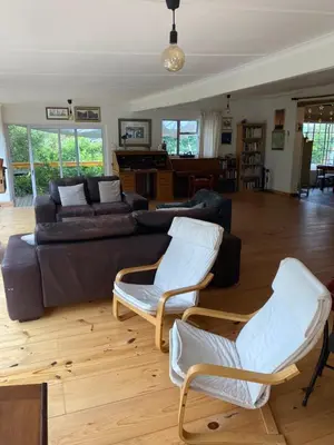 a living room with a couch and chairs and a piano at McBains in Breerivier