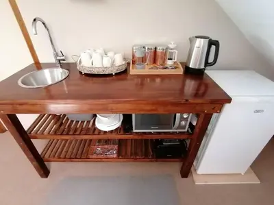 a wooden table with a sink and a coffee maker at Le Arc Manor House in Franschhoek