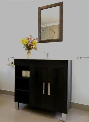 a bathroom vanity with a mirror and a sink at Franschhoek Studio in Franschhoek