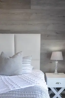 a bedroom with a white bed and a table with a lamp at 67 Whale Rock Estate, Hermanus in Hermanus