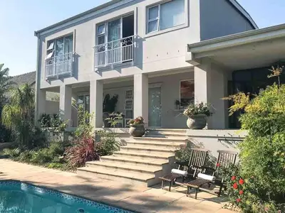 a house with a swimming pool in front of it at Protea Suite in Cape Town