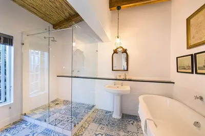 a bathroom with a tub and a sink and a shower at Bartinney Private Cellar Banhoek in Stellenbosch