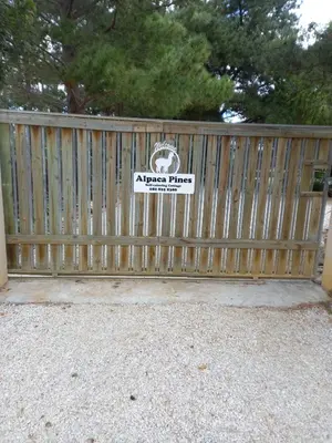 a wooden fence with a sign on it at Alpaca Self Catering Cottage Kleinmond in Kleinmond