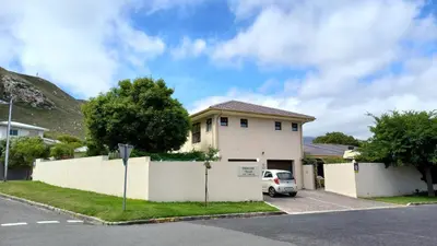 a house with a white fence in front of it at Steenbok House in Hermanus