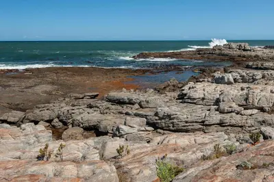 a rocky shoreline with the ocean in the background at 49 Whalerock in Hermanus