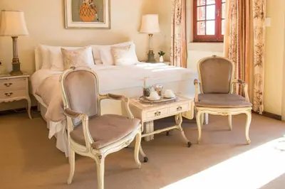 a bedroom with a bed and a table and chairs at Casa Mori House in Stellenbosch