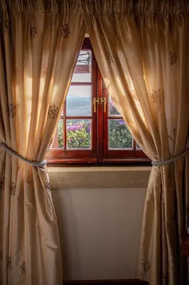 a window with a curtain in a room at Casa Mori House in Stellenbosch