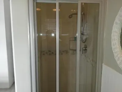 a shower with a glass door in a bathroom at 504 Witsand in Bloubergstrand