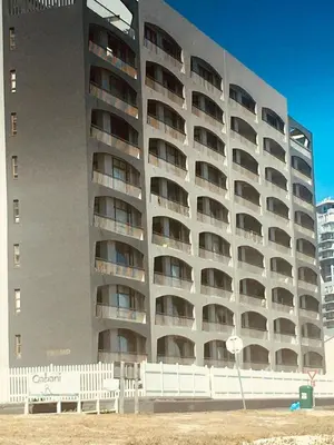 a large apartment building with balconies on a beach at 504 Witsand in Bloubergstrand